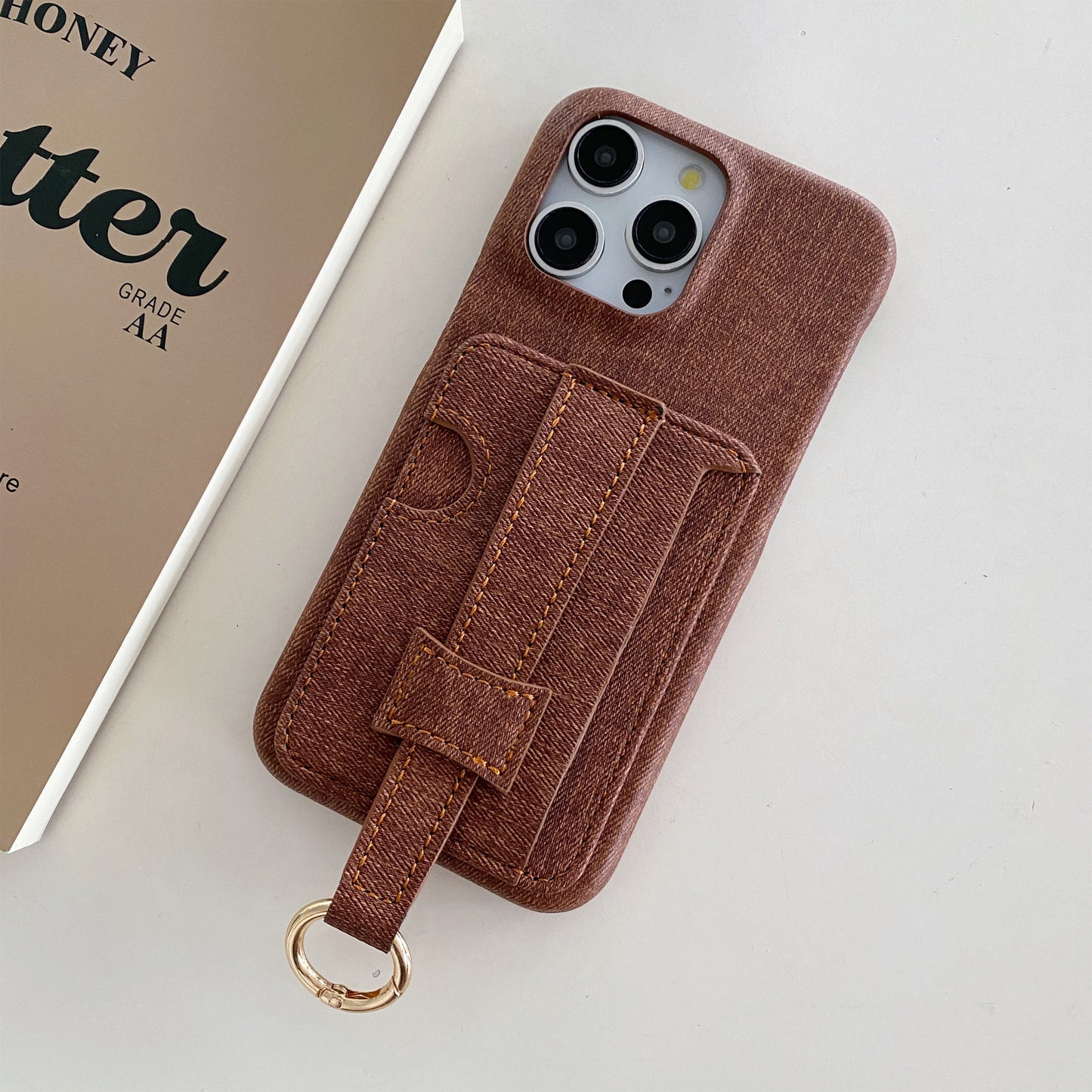 Denim-textured iPhone case with wrist strap and ring holder