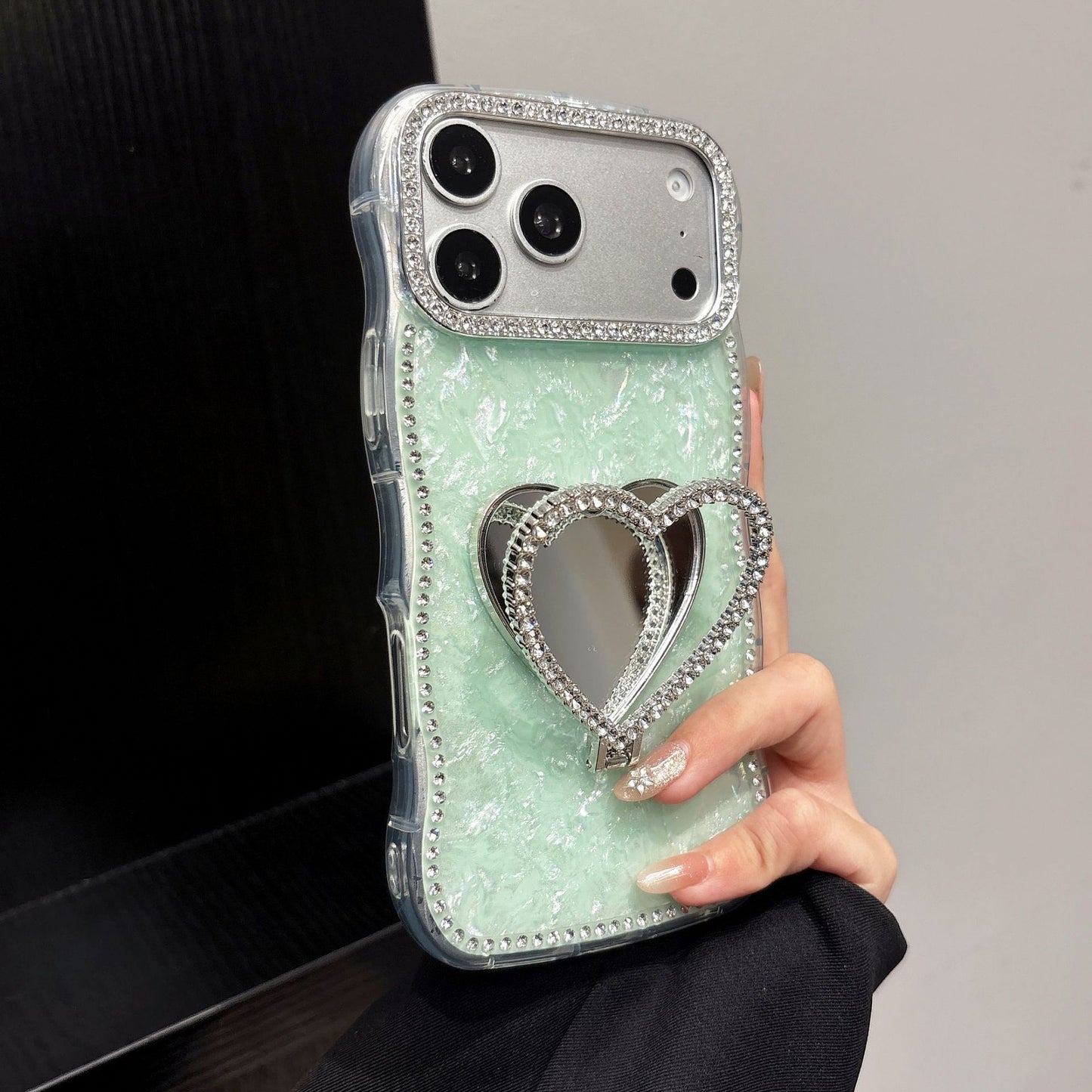 Rhinestone-studded heart-shaped mirror stand iPhone case with a shell pattern