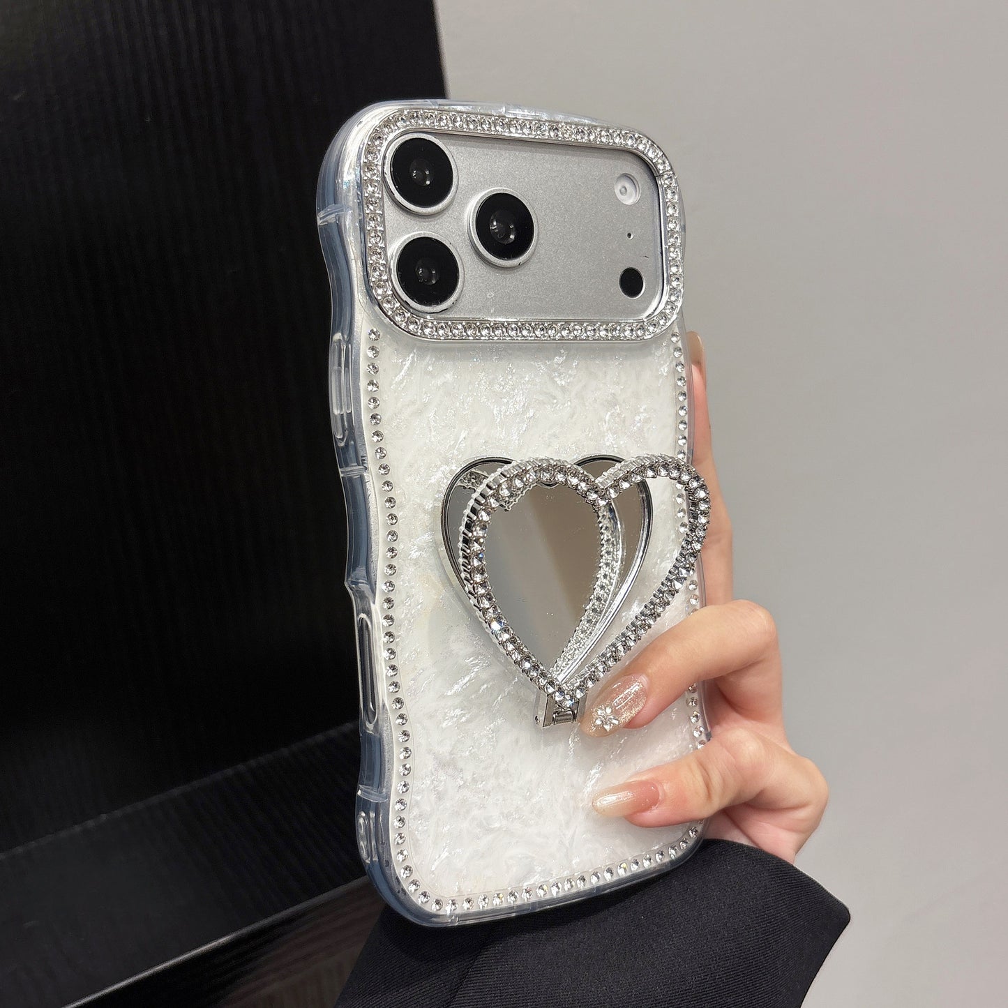 Rhinestone-studded heart-shaped mirror stand iPhone case with a shell pattern